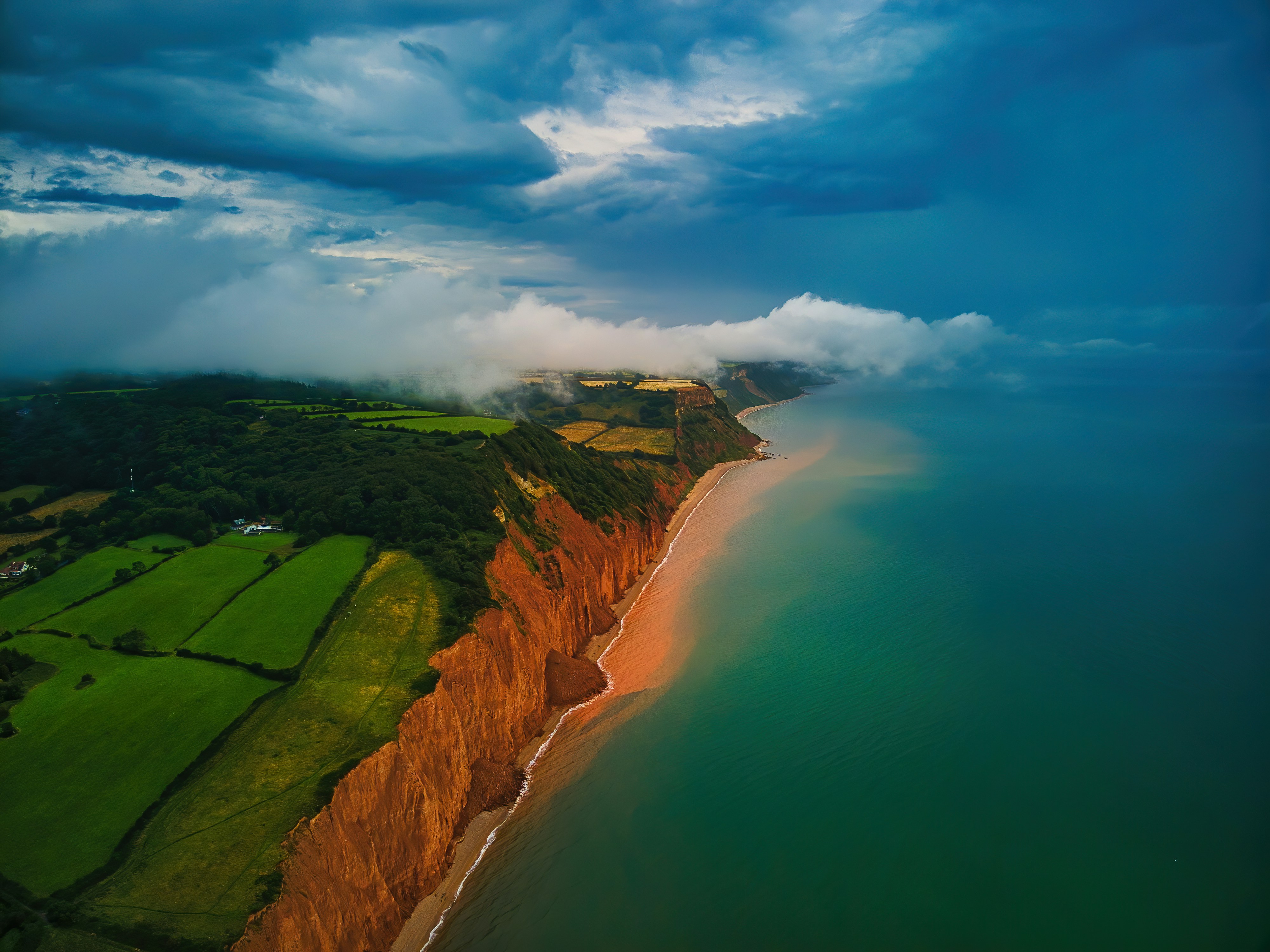 Cloud Cover. Summer storm clouds barrelling across the cliffs of the Jurassic Coast, Sidmouth, UK